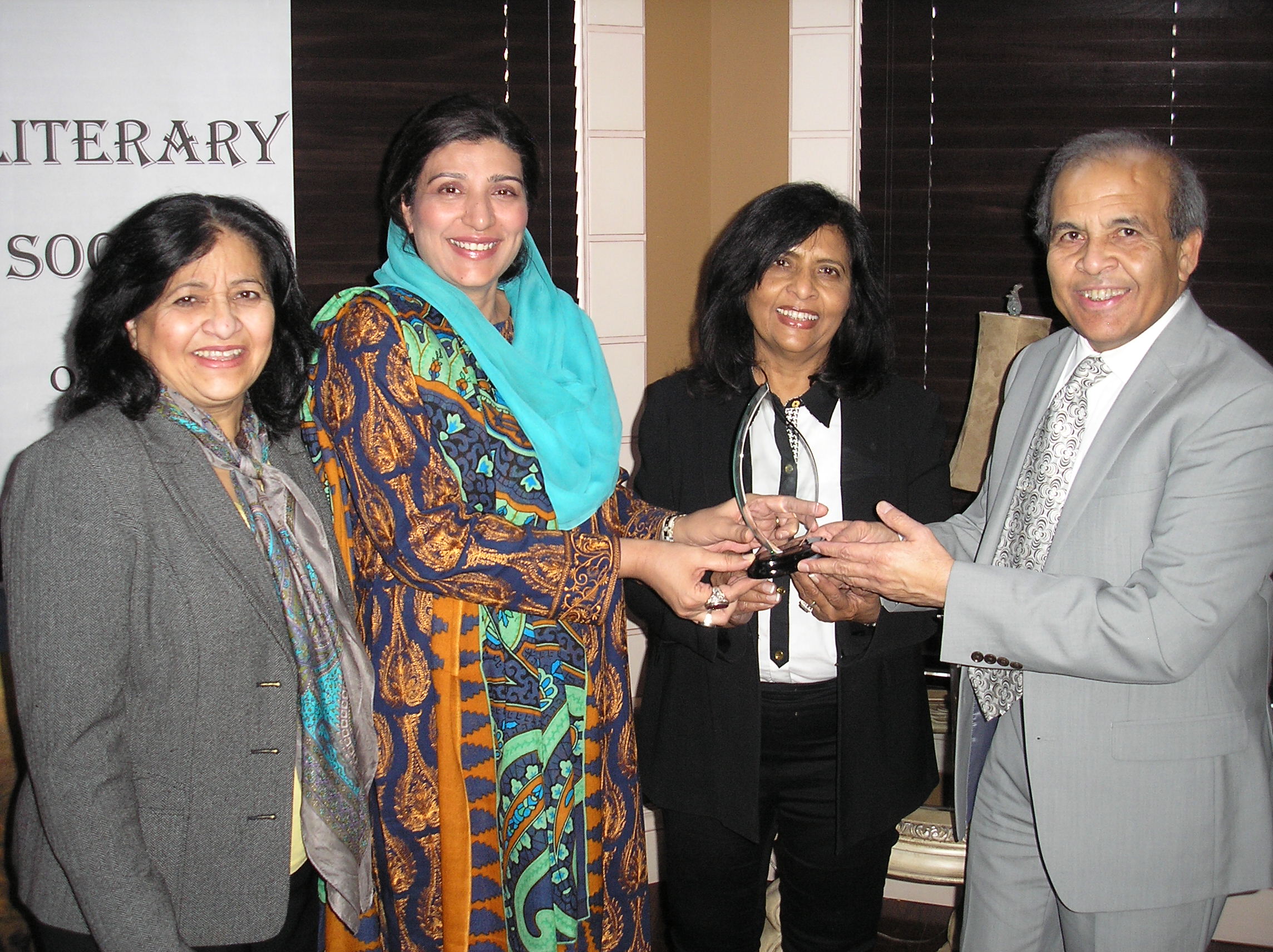 Iqbal Haider President JLSC and members are presenting award to Farzana Raja, in Canada